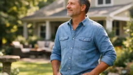 person showing ownership intent while standing in front of a house